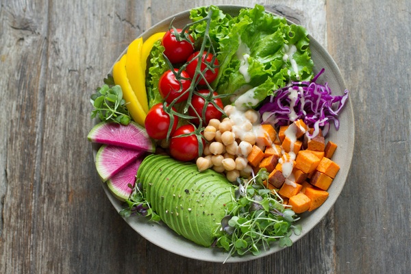 Fresh plate with vegetables and grains on a table